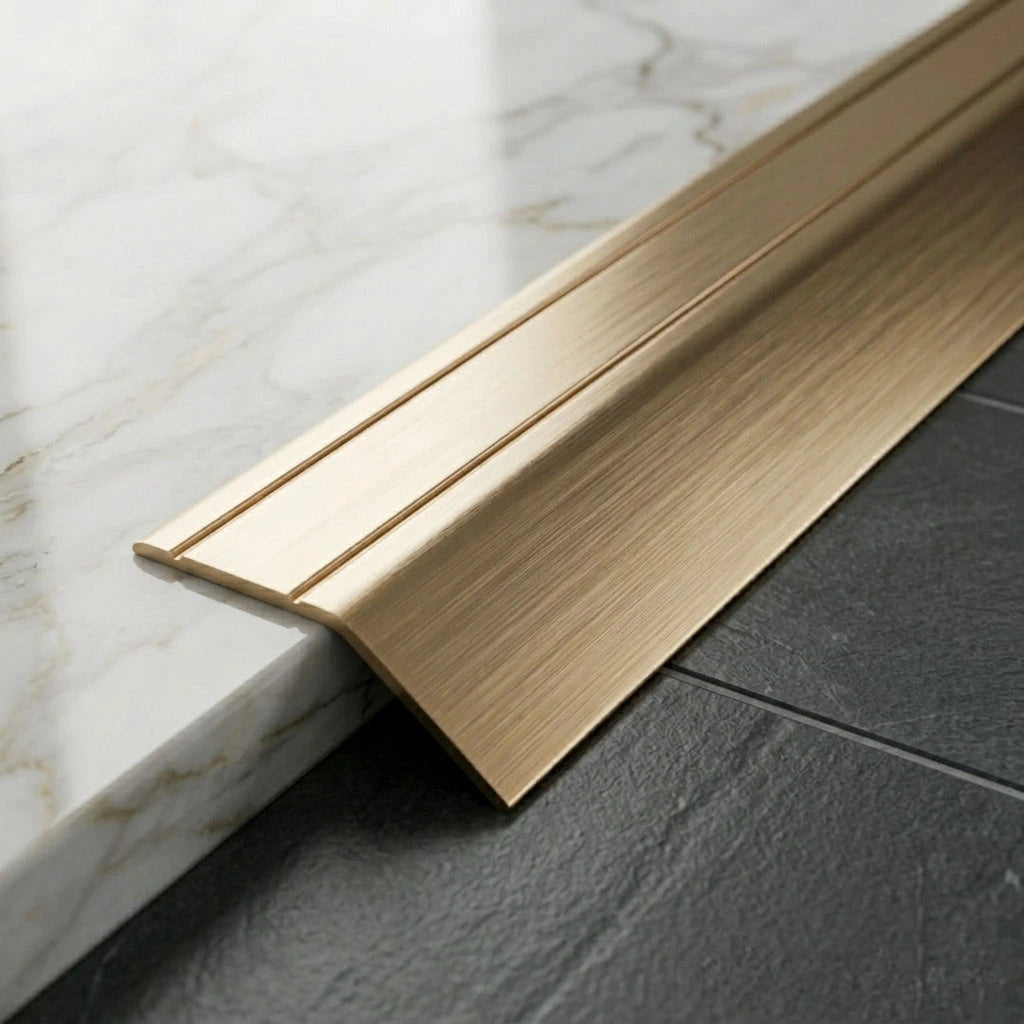 Anodised aluminium self-adhesive door threshold bar, close up, Golden finish