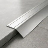 Anodised aluminium self-adhesive door threshold bar close up Silver finish