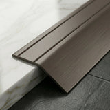 Anodised aluminium self-adhesive door threshold bar close up Champagne finish