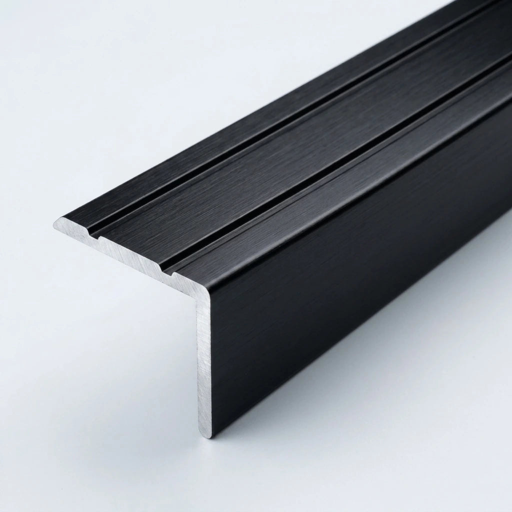 Black brushed aluminum stair nosing profile with anti-slip grooves, shown in close-up on a white background.