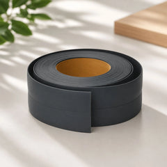 Flexible PVC Skirting Board roll in Dark Grey, self-adhesive wall base molding for floor edging and corner protection.