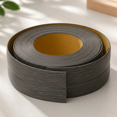 Flexible PVC Skirting Board roll in Gray ASH wood finish, self-adhesive wall base molding for floor edging and corner protection.