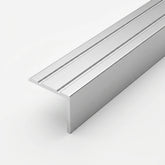 Silver brushed aluminum stair nosing profile with anti-slip grooves, shown in close-up on a white background.