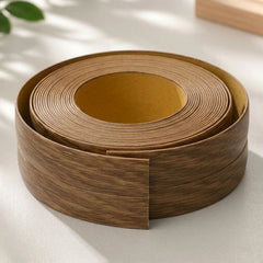 Flexible PVC Skirting Board roll in Light Oak wood finish, self-adhesive wall base molding for floor edging and corner protection.