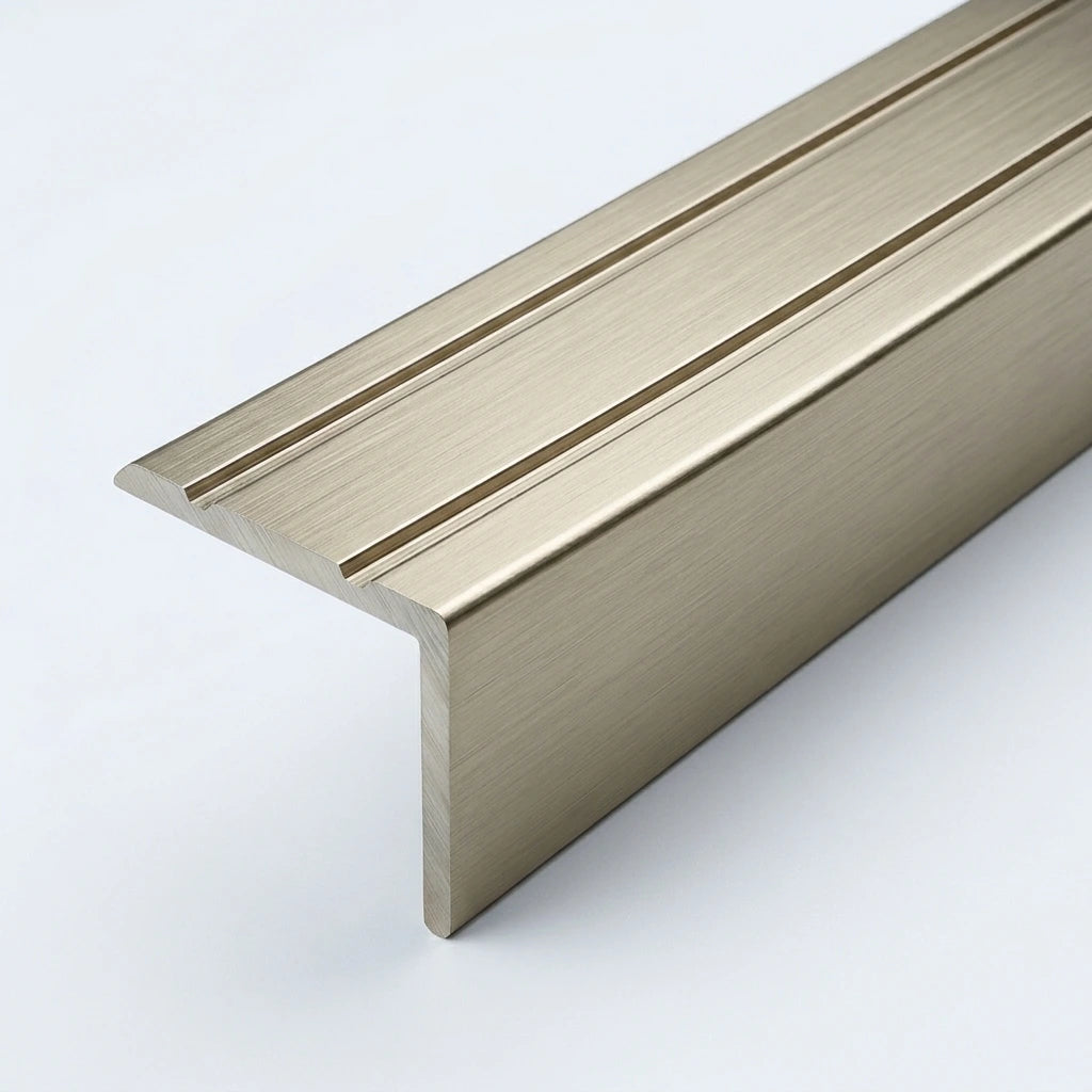 Inox brushed aluminum stair nosing profile with anti-slip grooves, shown in close-up on a white background.
