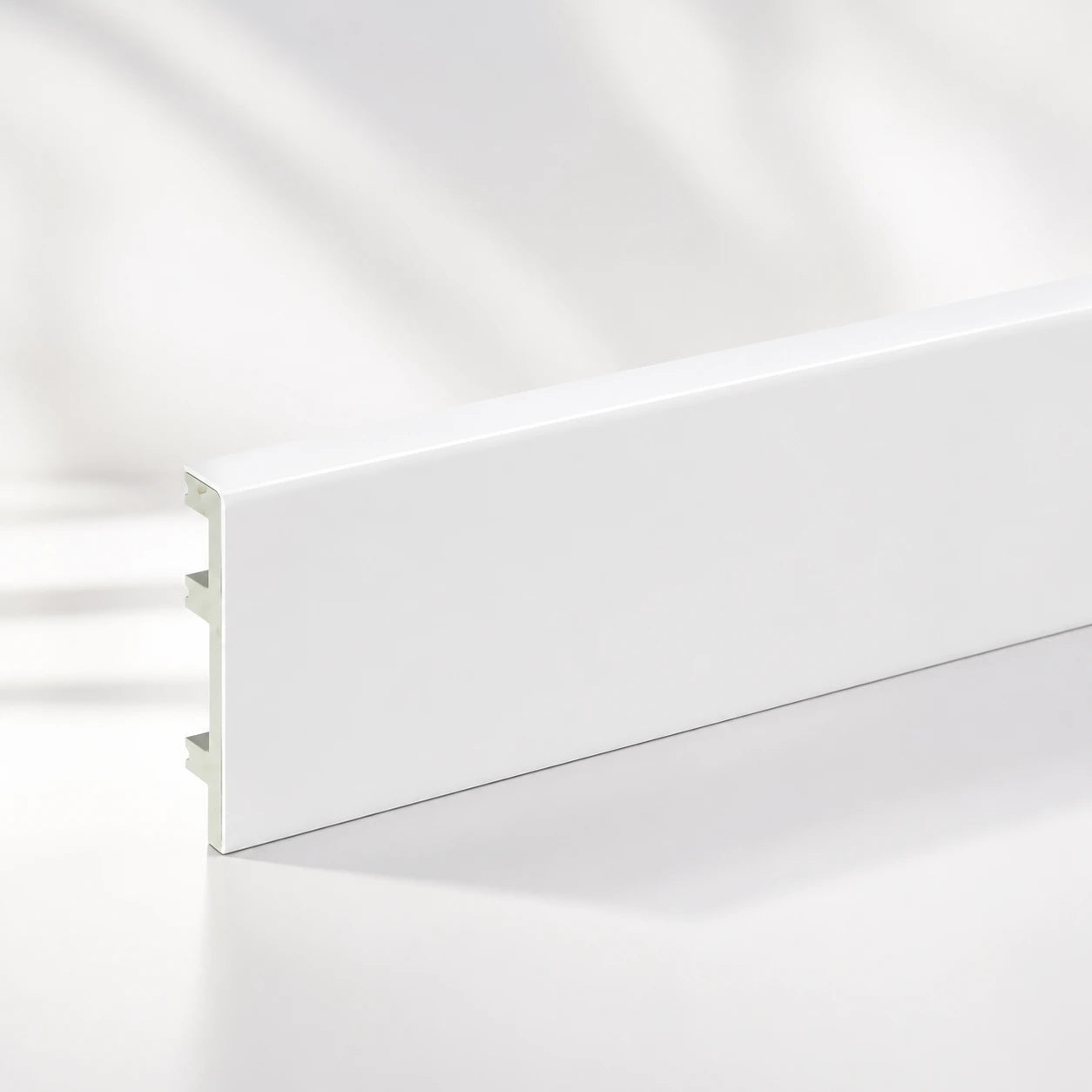 White PVC skirting board fitted in living room hallway UK