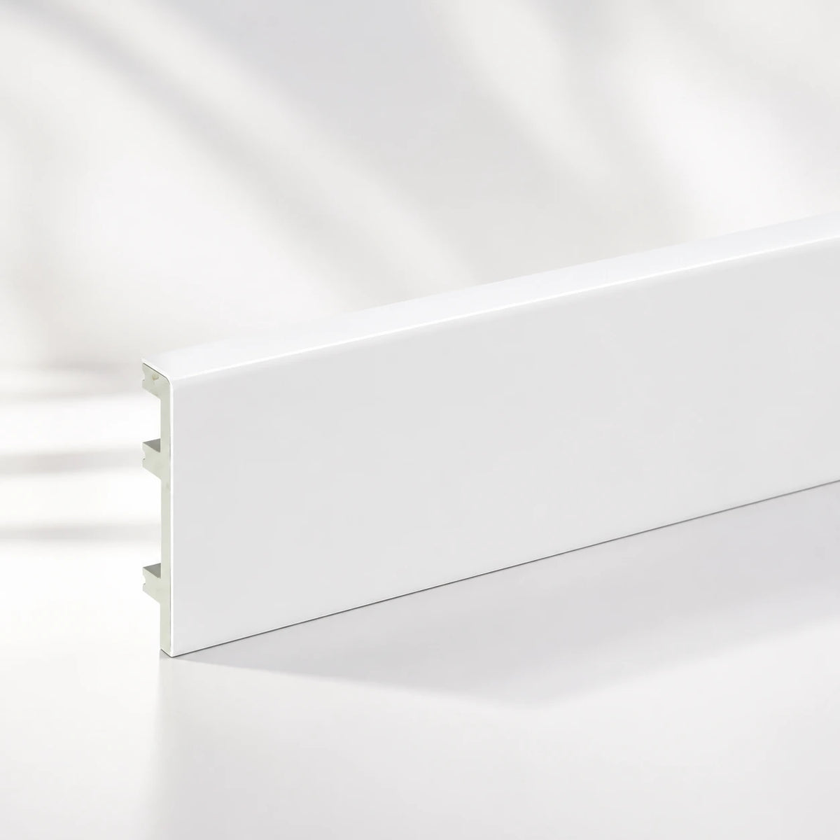White PVC skirting board fitted in living room hallway UK