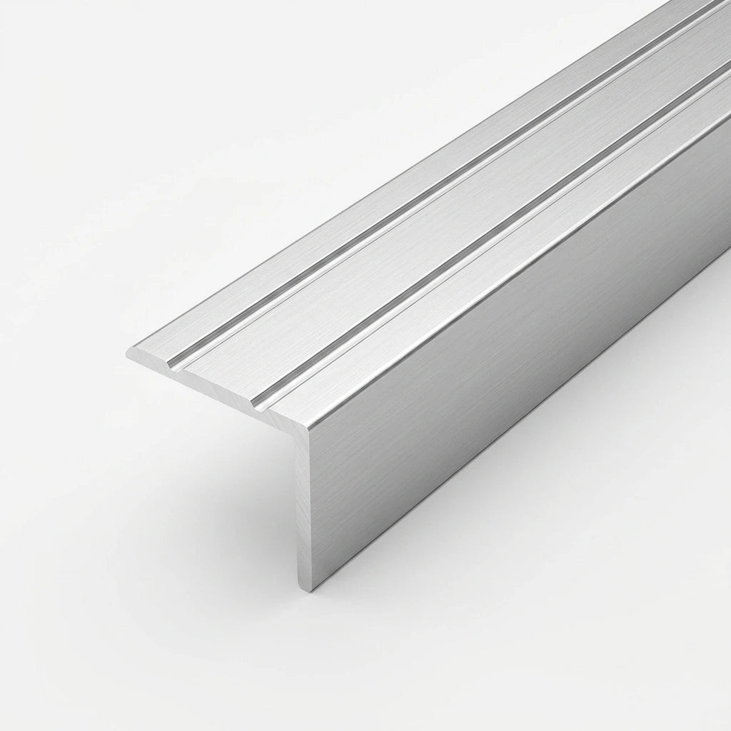 Silver brushed aluminum stair nosing profile with anti-slip grooves, shown in close-up on a white background.